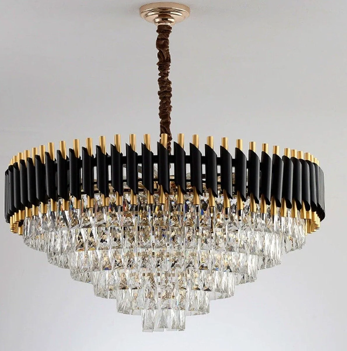 Modern crystal chandelier with black and gold metal frame, crystal lampshades, and matching wall lights in modern style