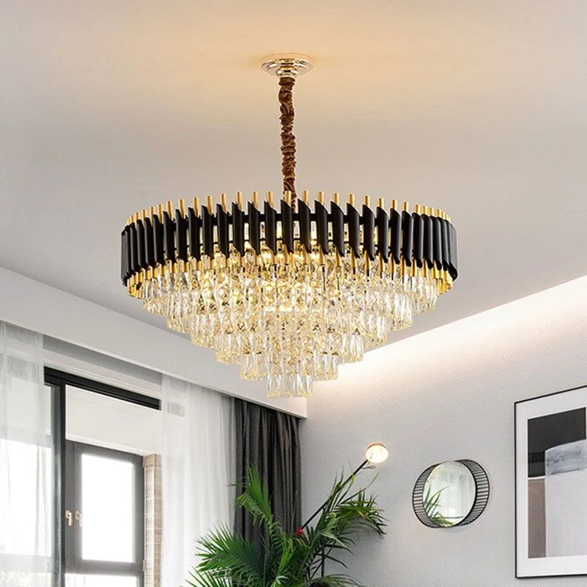 Modern crystal chandelier with black and gold finish, round design, and matching wall lights on white background