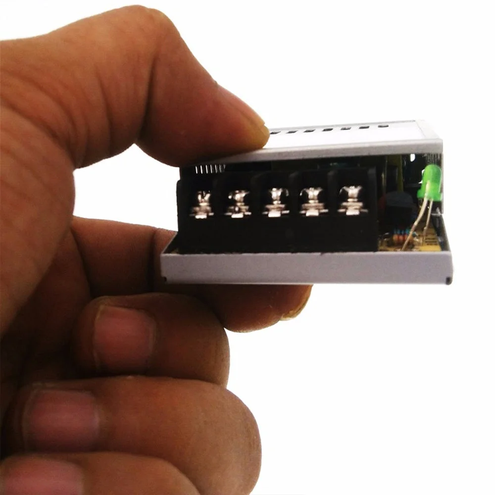 Slimline 12V DC transformer with aluminium casing, honeycomb ventilation, and screw terminal connections for LED strips