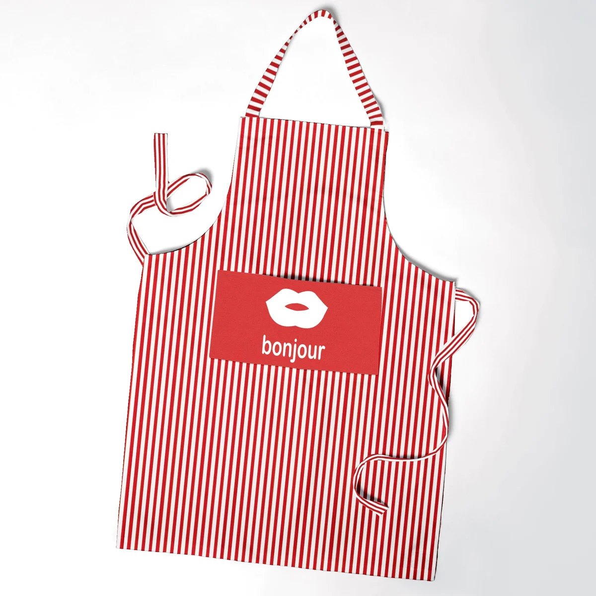 Unisex cooking apron in cotton with adjustable neck strap, long waist ties, and a large front pocket for kitchen essentials