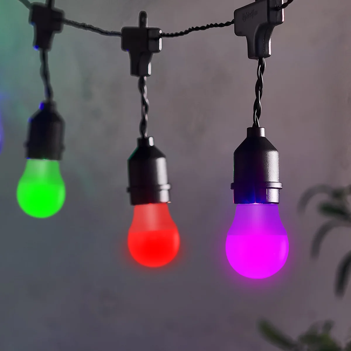 E27 coloured bulb glowing in multiple vibrant colors, ideal for party and decorative lighting with 360° illumination