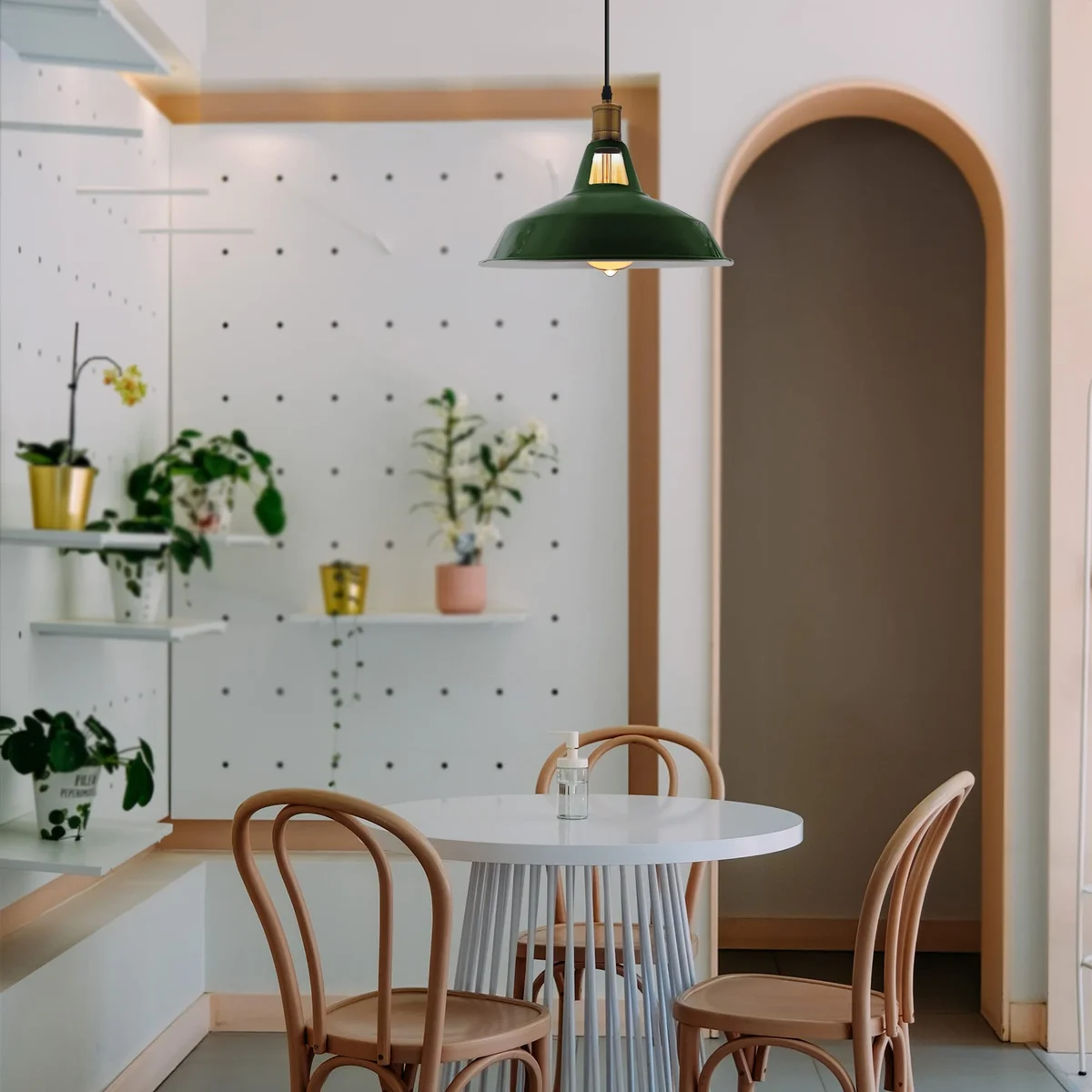 Three metal retro pendant light shades in vintage style with adjustable cables and ceiling mounts on white background