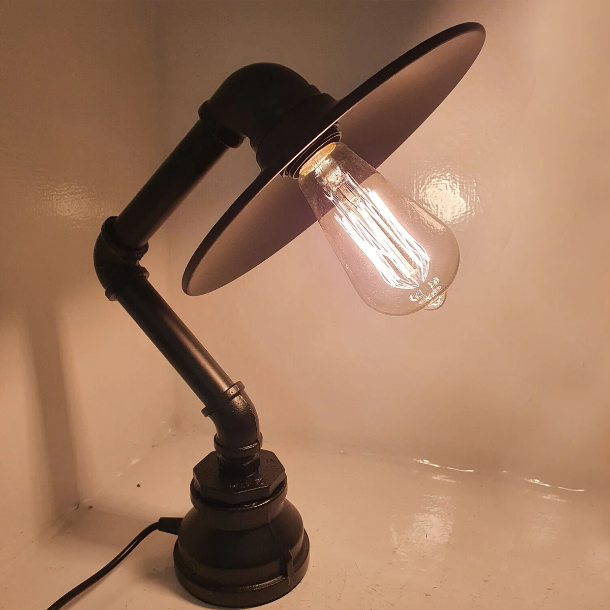 Vintage industrial table lamp with brushed copper pipe design and flat metal lampshade on a white background