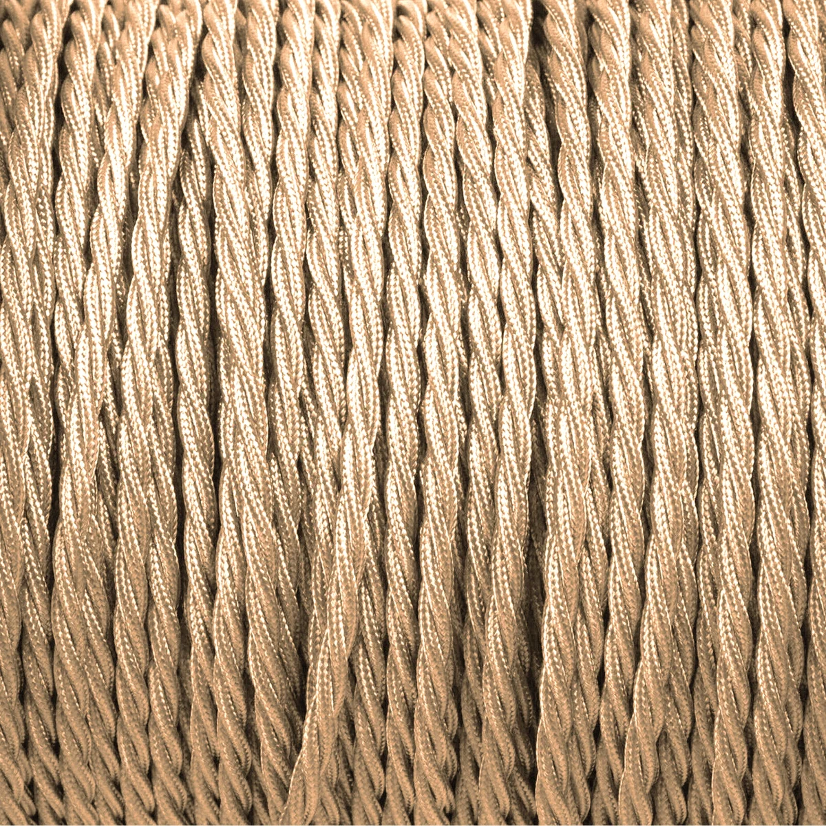 Light gold twisted fabric lamp cord with two cores, silk braided texture, coiled on a white background