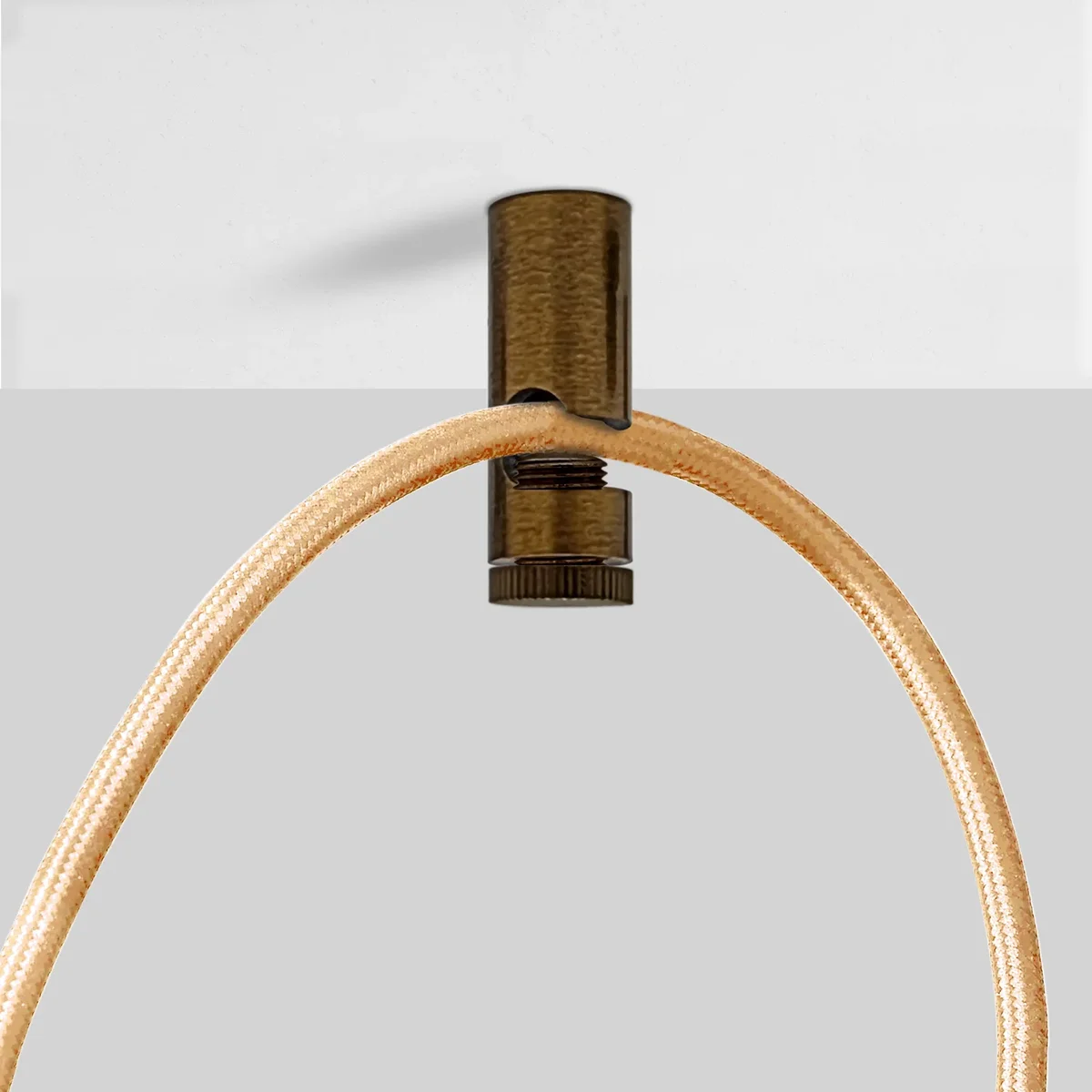 Single modern metal cable hook for walls and ceilings with mounting screw and plastic wall anchor on white background