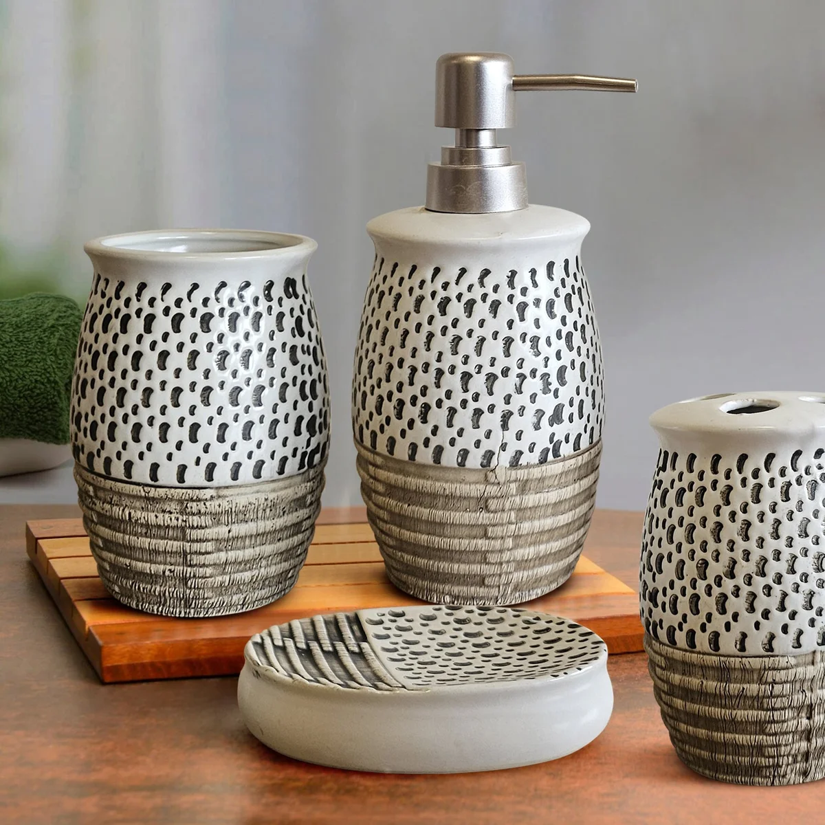 White modern ceramic bathroom accessories set with soap dispenser, toothbrush holder, tumbler, and soap dish on counter