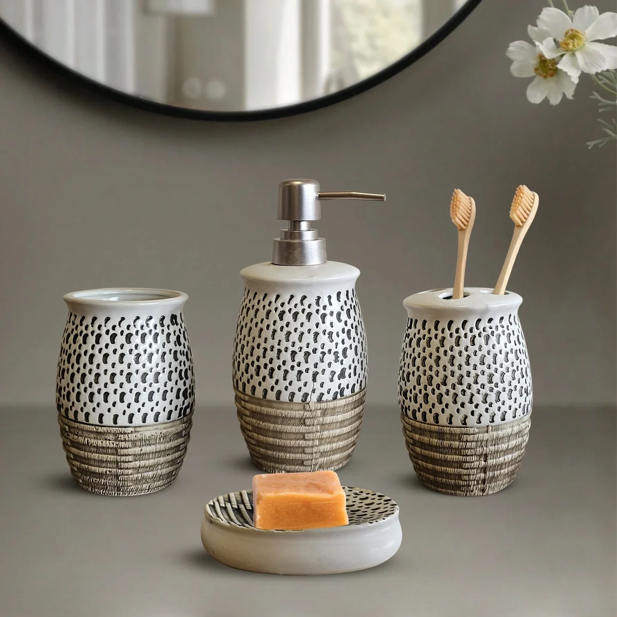 White ceramic bathroom soap dispenser with manual pump, part of a modern 4-piece bathroom accessories set