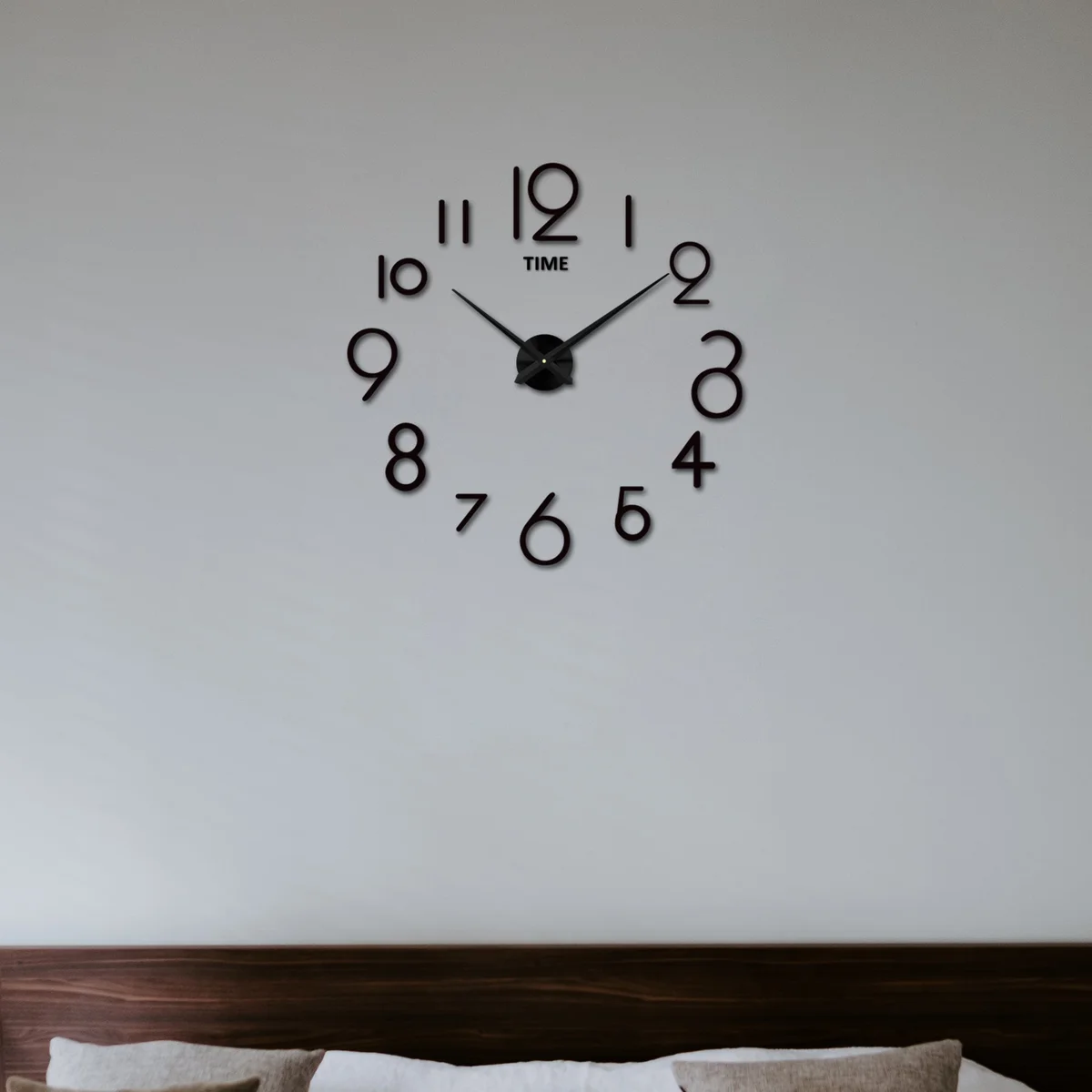Modern DIY large number wall clock with 3D mirror stickers on a smooth wall in a living room setting