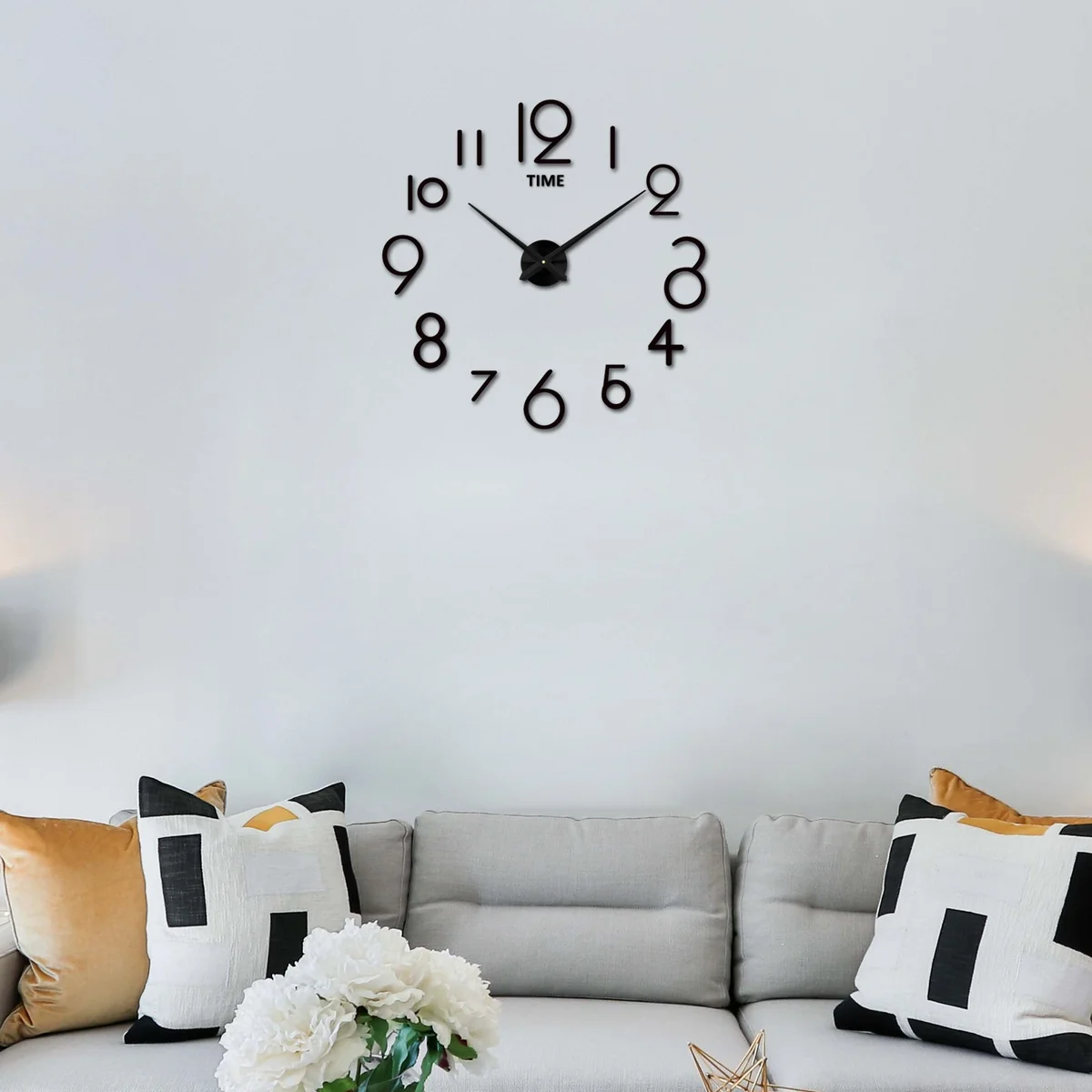 Large 3D mirror wall clock with black acrylic numbers and silver reflective surfaces on a white wall background