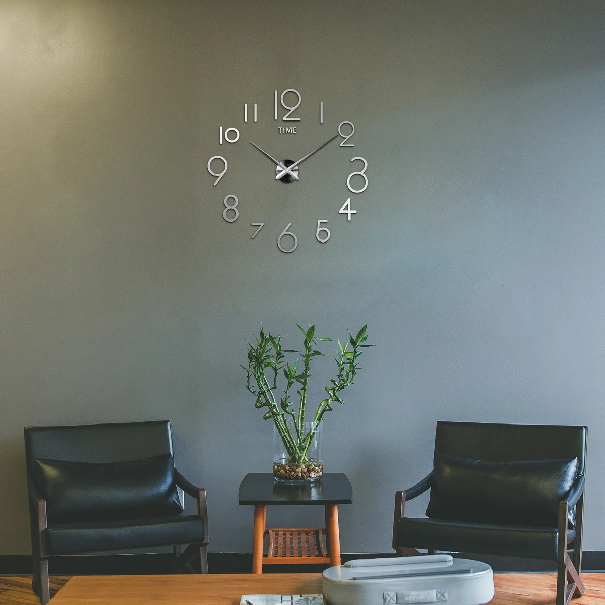 Modern 3D mirror adjustable size clock with large numbers on a smooth wall in a stylish home office setting