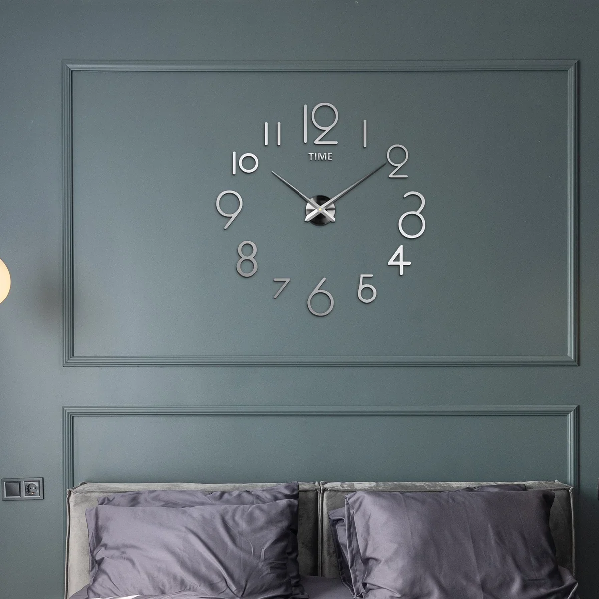 Large modern EVA foam clock with 3D mirror numbers mounted on a smooth indoor wall in a stylish living room setting