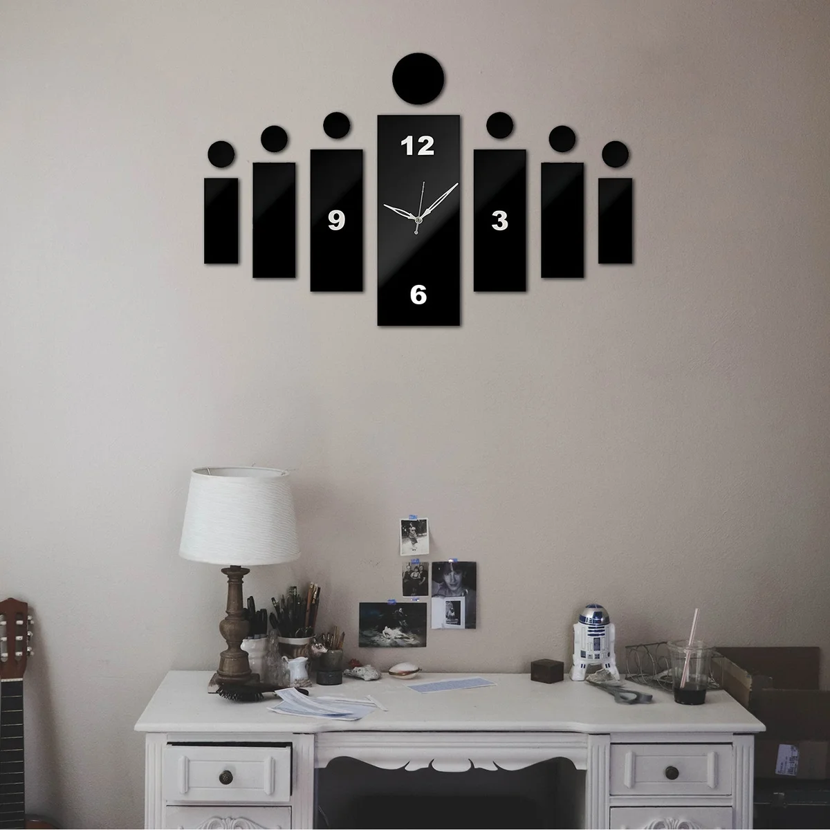 Modern 3d wall clock with large black acrylic numbers and frameless design on white wall background