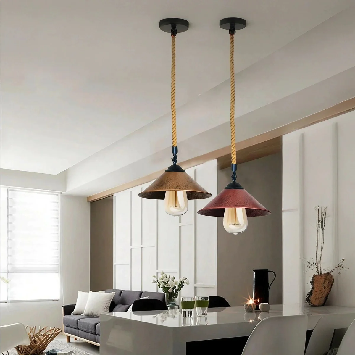 Rustic red industrial metal light pendant with hemp rope suspension hanging from ceiling against white background