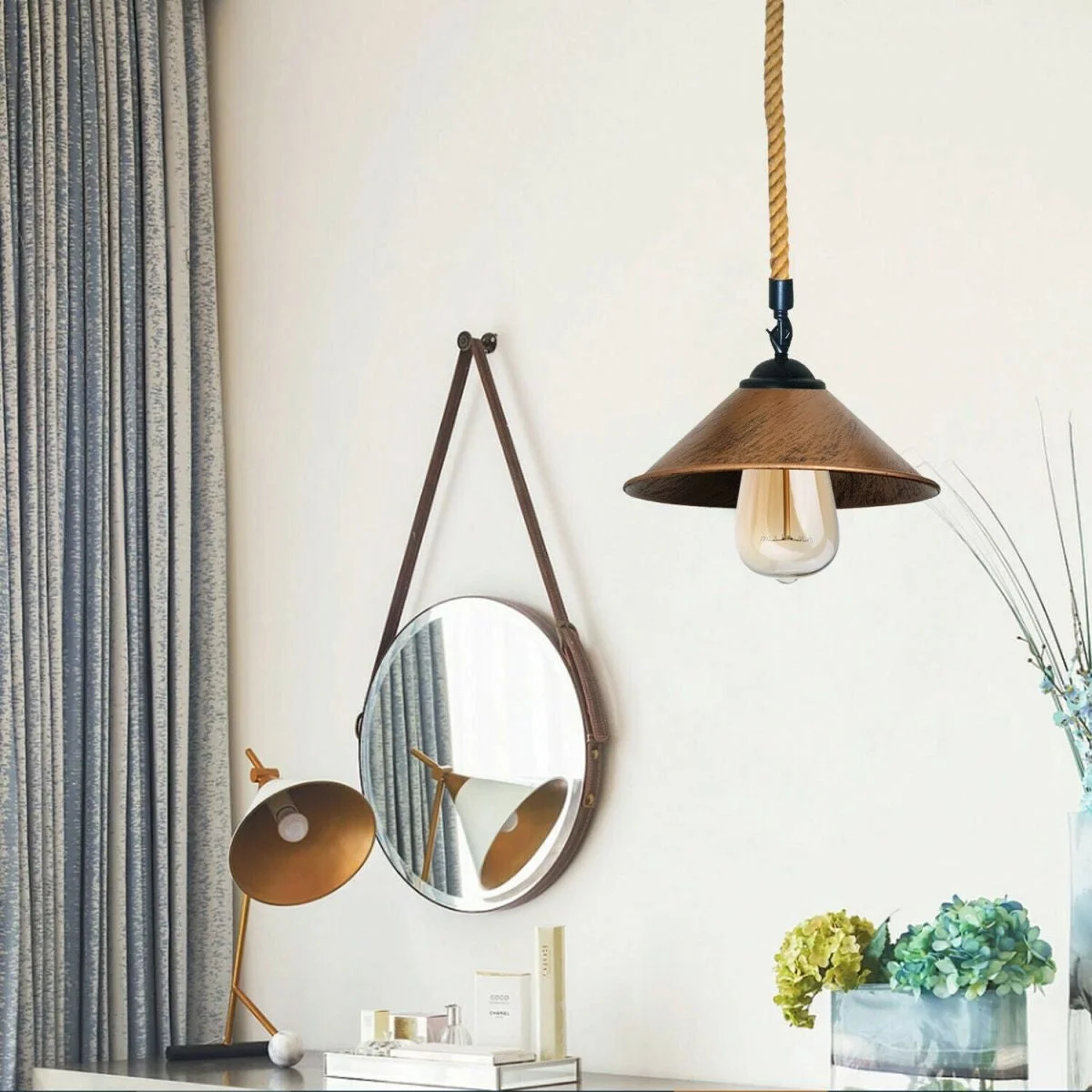 Rustic red brass pendant light with hemp rope suspension hanging from ceiling, showing modern industrial design details