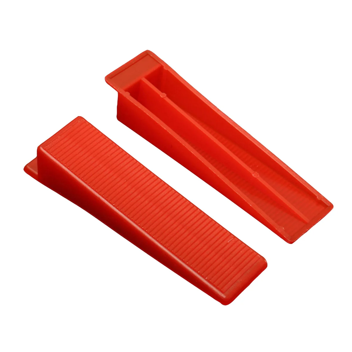 Set of yellow, red, and orange PVC tile wedges arranged in a row, used for floor and wall tile leveling and spacing