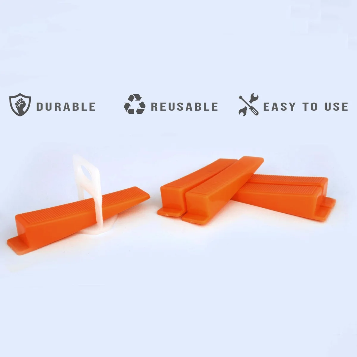 Set of 100 yellow, red, and orange T-shaped tile leveling wedges made of durable PVC for floor and wall tile installation