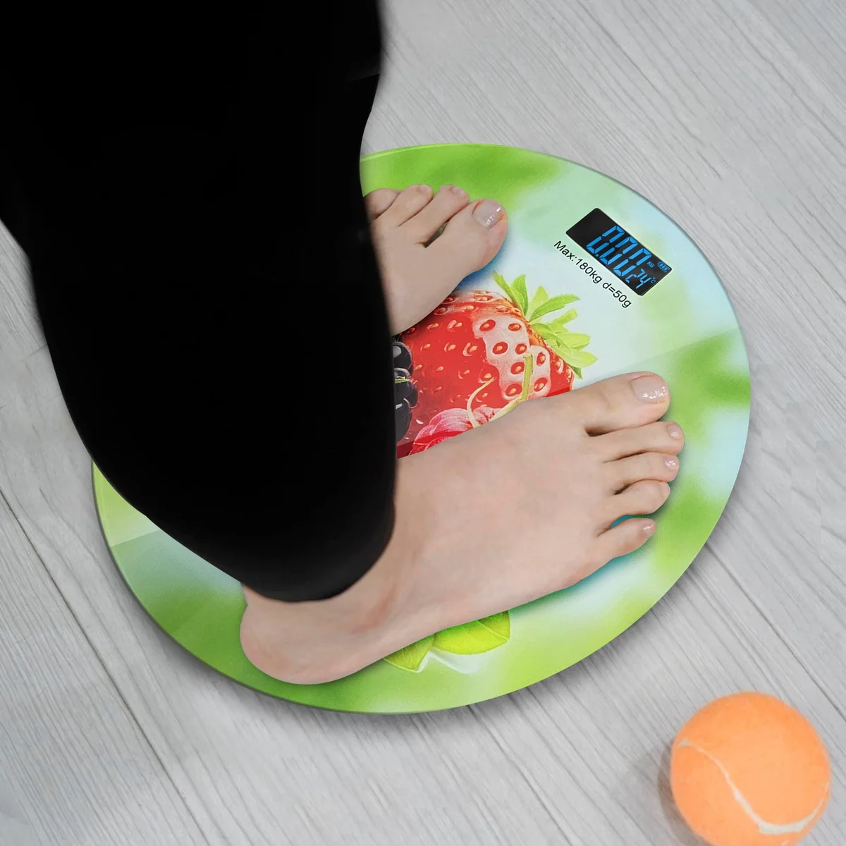 Round digital scales with printed design and clear LCD display scales showing weight measurement in kilograms