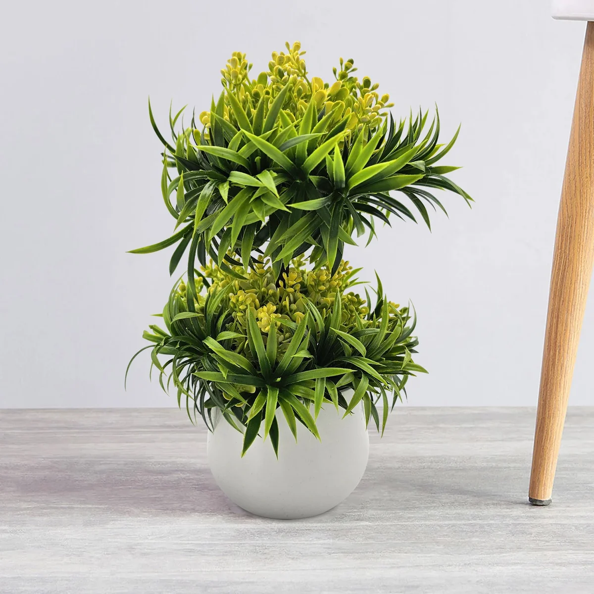 Two small artificial bonsai trees in black pots, ideal for indoor or outdoor decoration, shown side by side