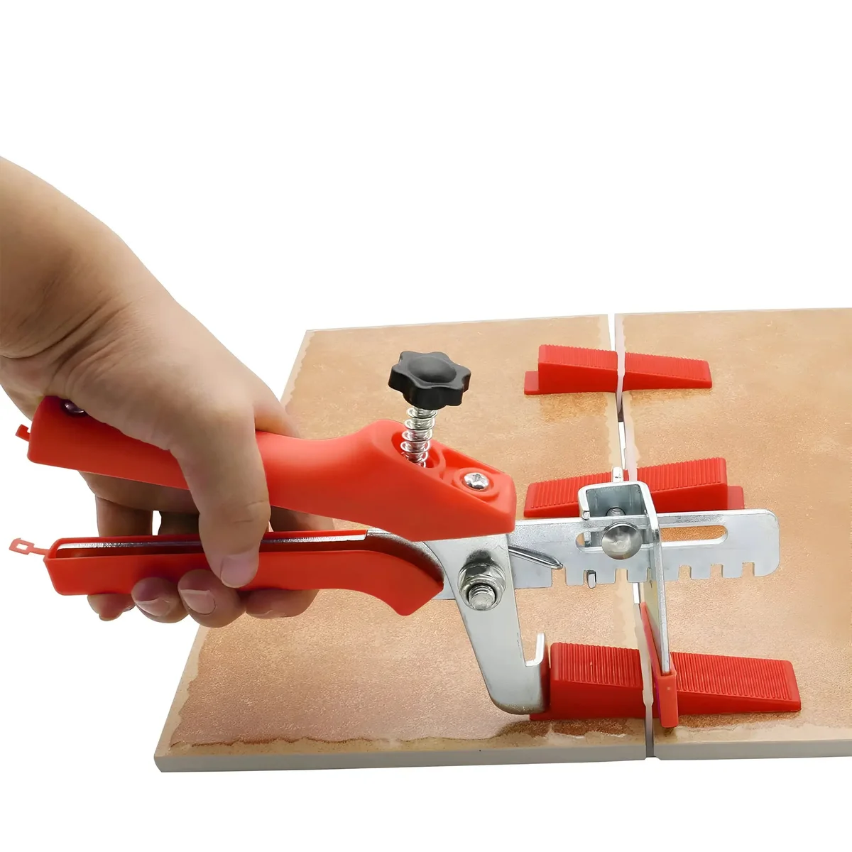 Tile leveling pliers with ergonomic orange and black handle alongside reusable tile spacers for even tile installation