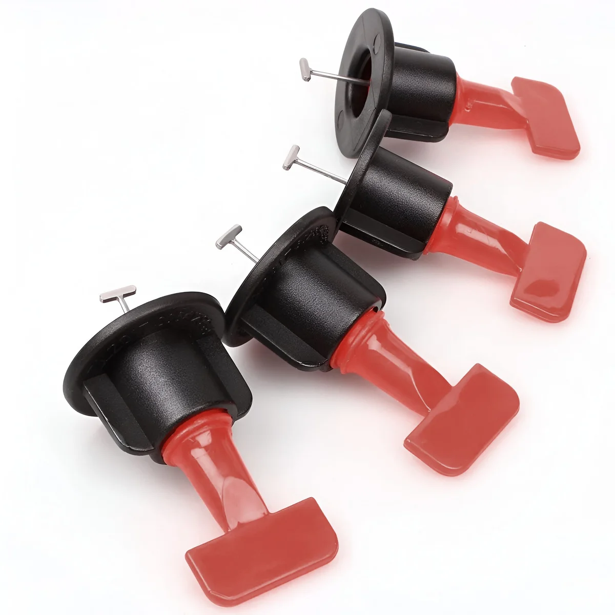 Set of 50 reusable T-shape tile leveling system clips with black caps and red handles for floor and wall tiles installation