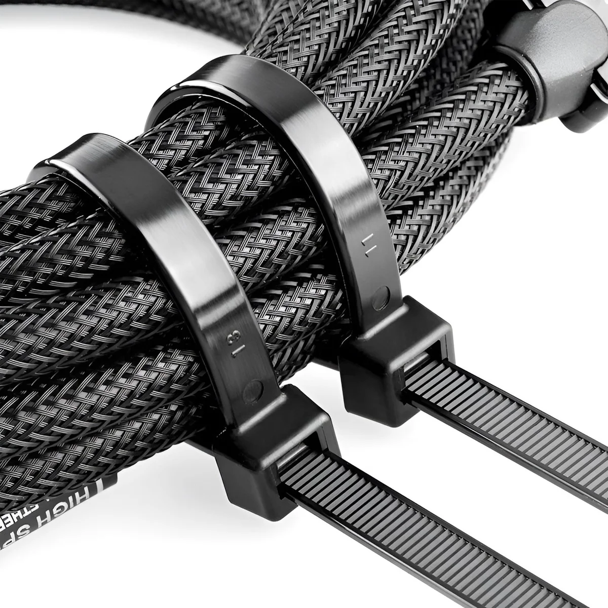 Bundle of black heavy duty cable ties neatly arranged, showing their self-locking design and nylon material texture