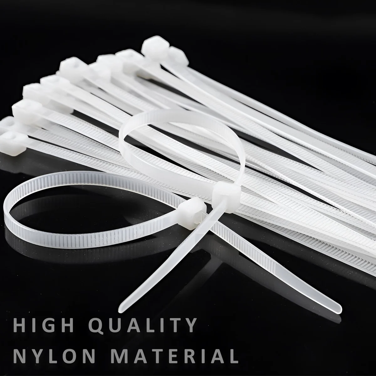 Bundle of white nylon zip ties neatly arranged on a plain background, showing their self-locking design and smooth finish