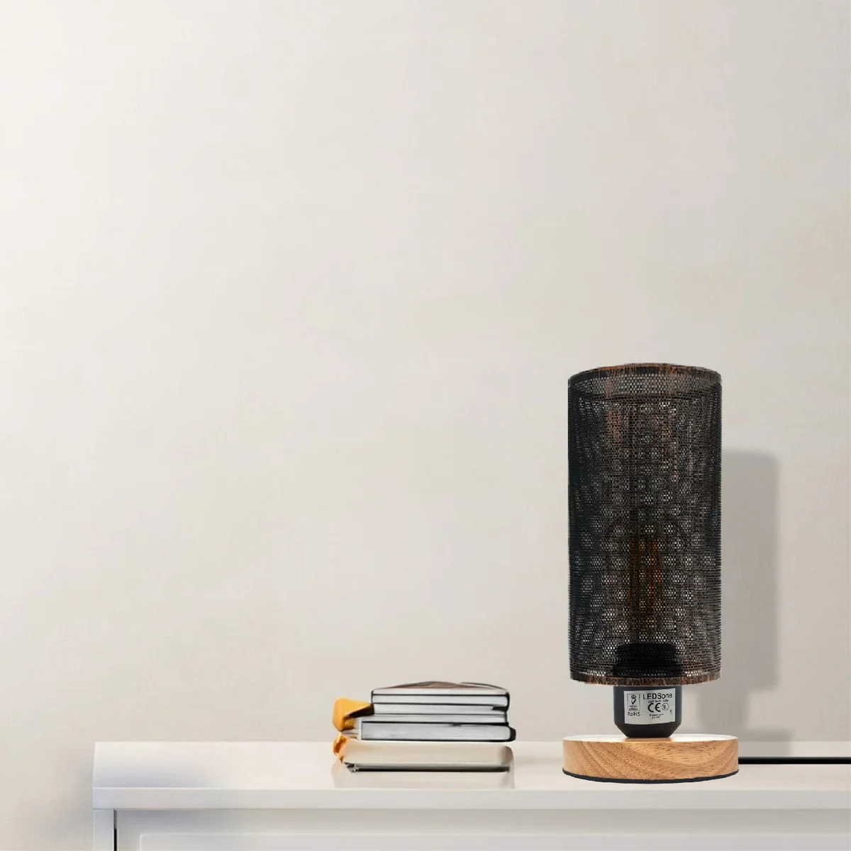 Retro wooden bedside table lamp with metal wire cage lamp shade and natural wood base on white background