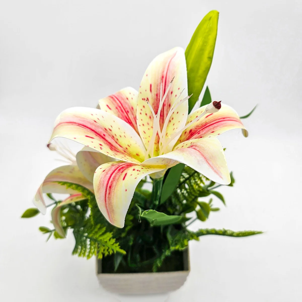 Two silk artificial lily flowers in pots displayed on a wooden table, ideal indoor artificial plants for decoration