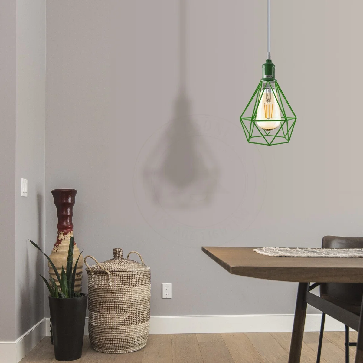 Vintage metal pendant light with industrial cage design hanging from ceiling, showing black spray-painted finish and cable details