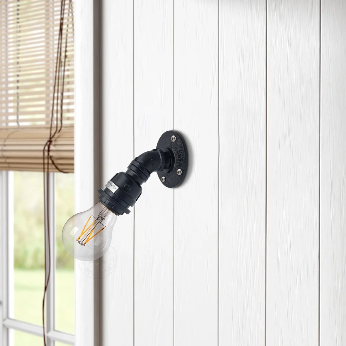 Black vintage wall lamp with industrial water pipe design and E27 base, mounted on a white wall background
