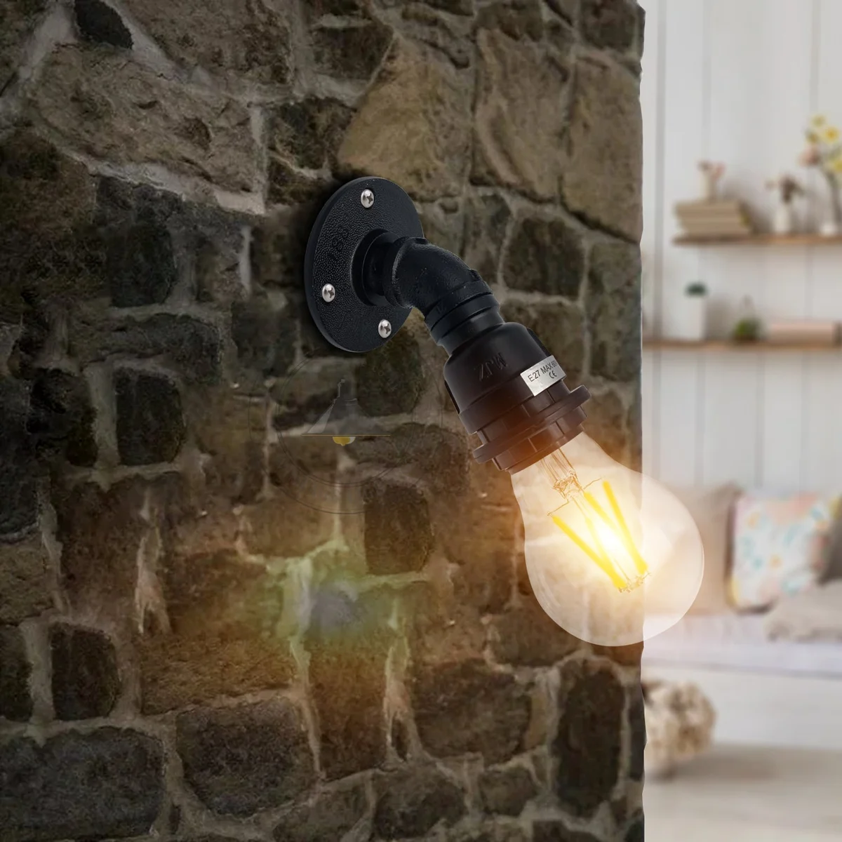 Black retro vintage industrial wall light with water pipe design and E27 bulb holder mounted on a white wall