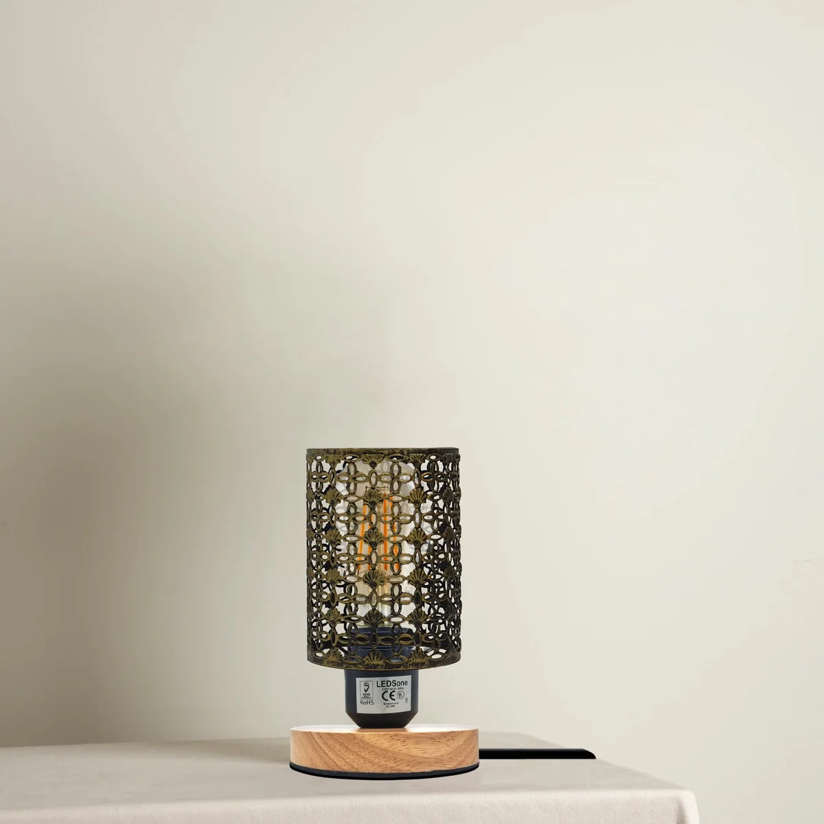 Vintage barrel cage wooden stand lamp with metal wire cage and plug-in switch on bedside table in rustic red color