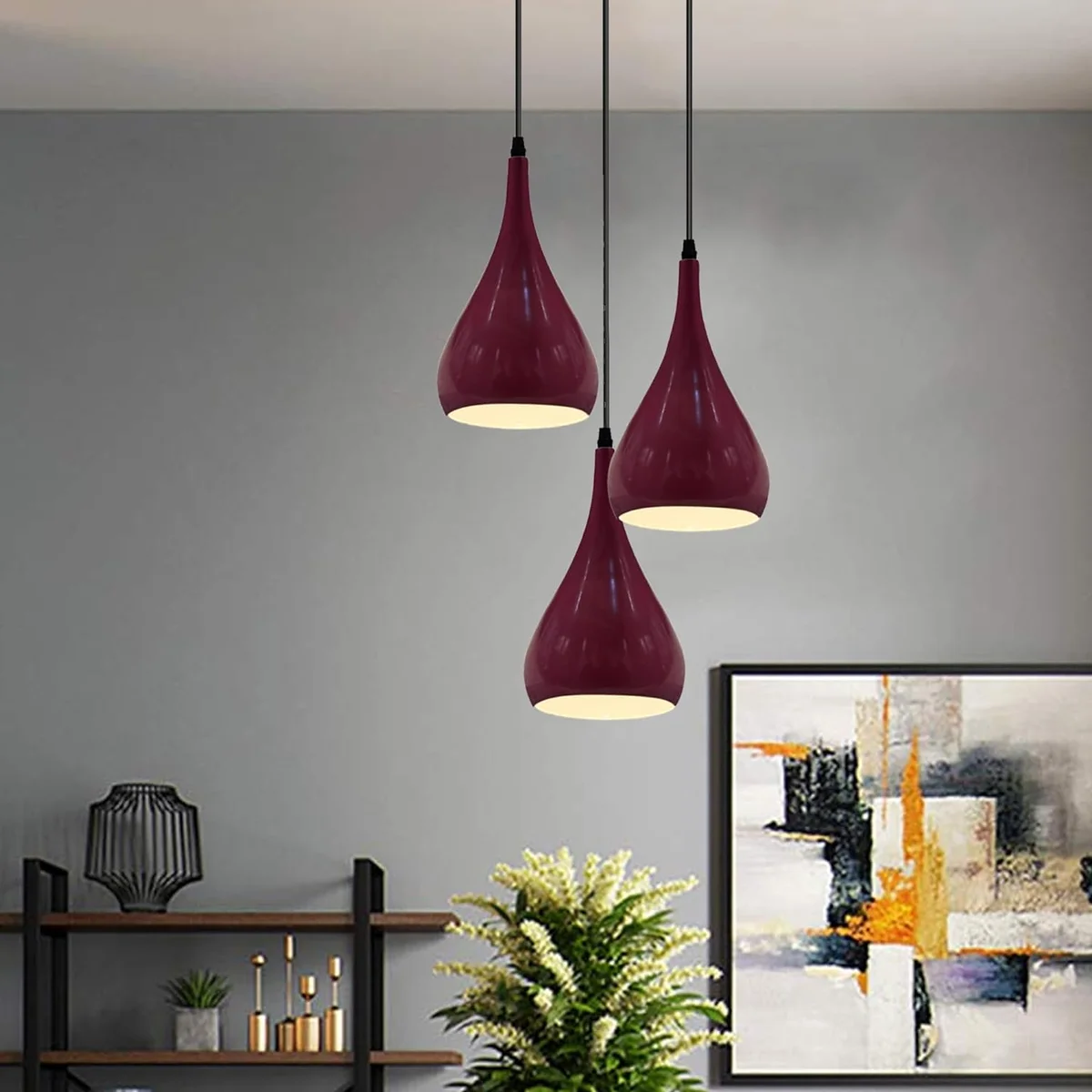 Three black teardrop shades hanging at different heights in the multi teardrop ceiling light with angled base plate