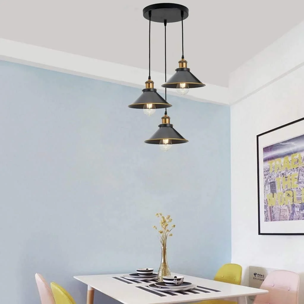 Vintage pendant light with three flat cone gold-edged shades hanging from adjustable cables on white background