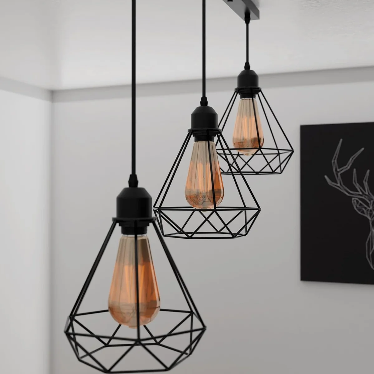 Black pendant light with three diamond-shaped wire cages and adjustable cables hanging from ceiling fixture