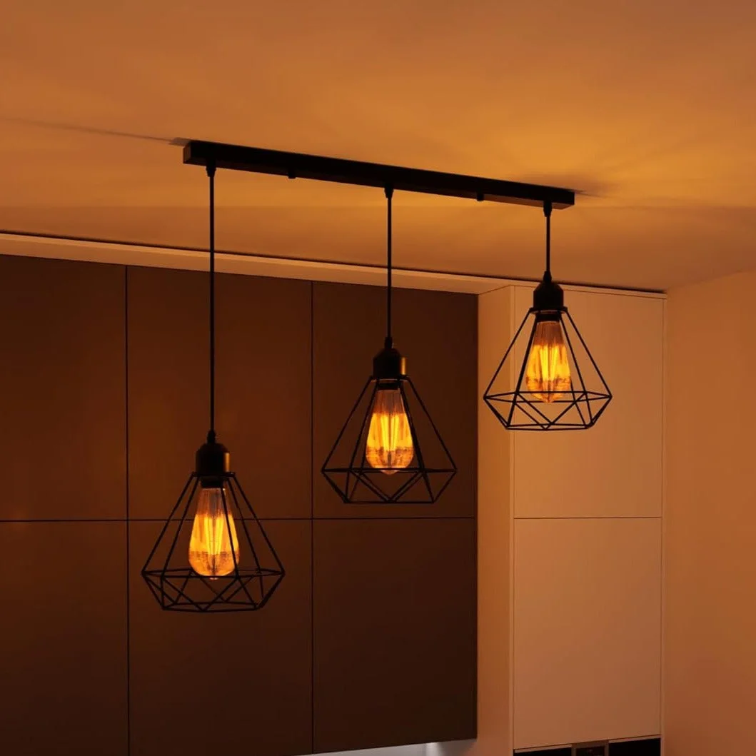 Black industrial 3 light ceiling fixture with adjustable cables and diamond-shaped wire cages hanging from ceiling