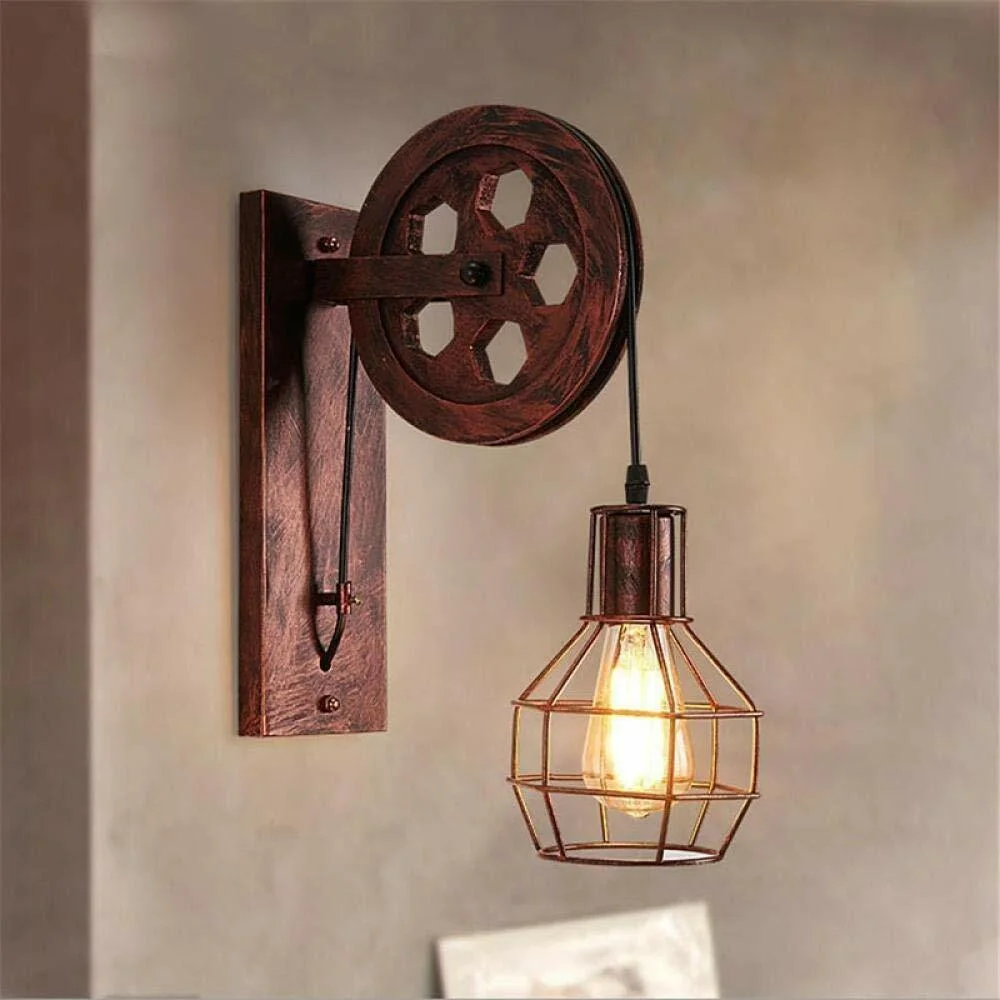 Industrial pulley wall light with wooden beam, iron cage shade, and functional pulley wheel for adjustable height lighting