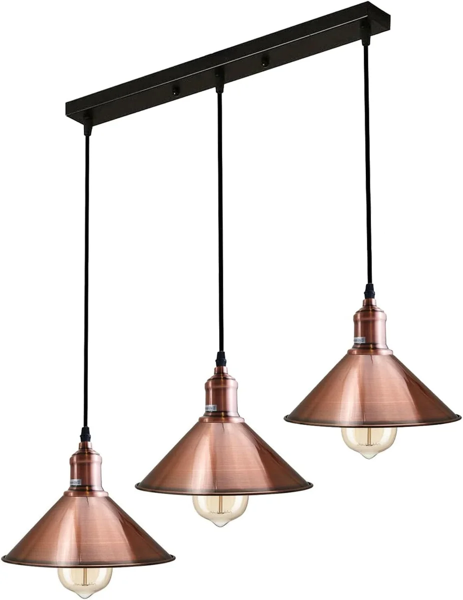 Three-head vintage pendant lighting fixture with black metal holders and copper shades hanging from adjustable cables