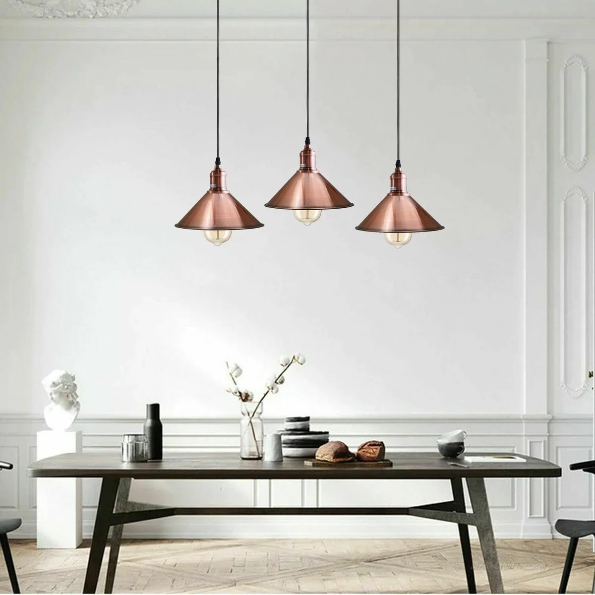 Three-head vintage industrial metal ceiling light with copper shades and black holder, hanging fixture for kitchen or bar area