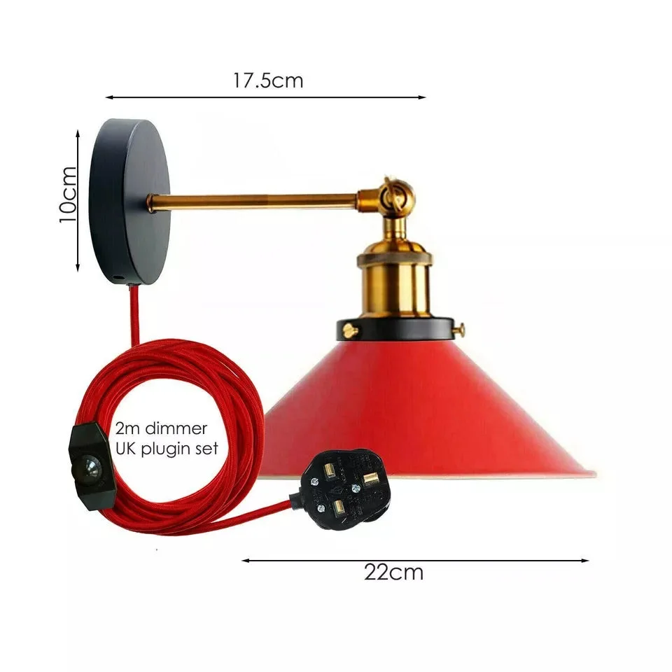 Vintage industrial plug in wall light with adjustable yellow brass arm and white cone shade mounted on black base