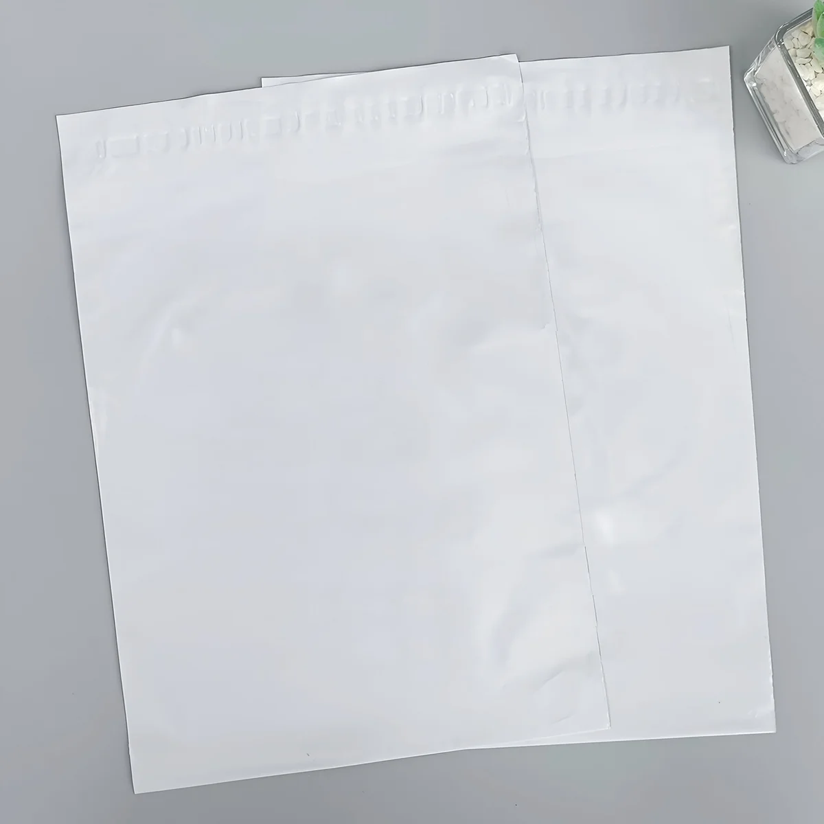 Stack of strong plastic mailing bags with self-adhesive closure, measuring 17cm by 30cm, made of durable polyethylene