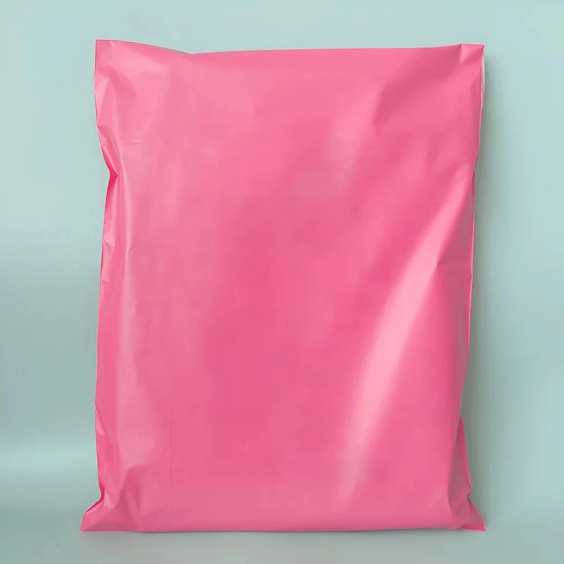 Stack of clear self-adhesive mailing bags made from durable polyethylene, sized 32x45cm for secure packaging