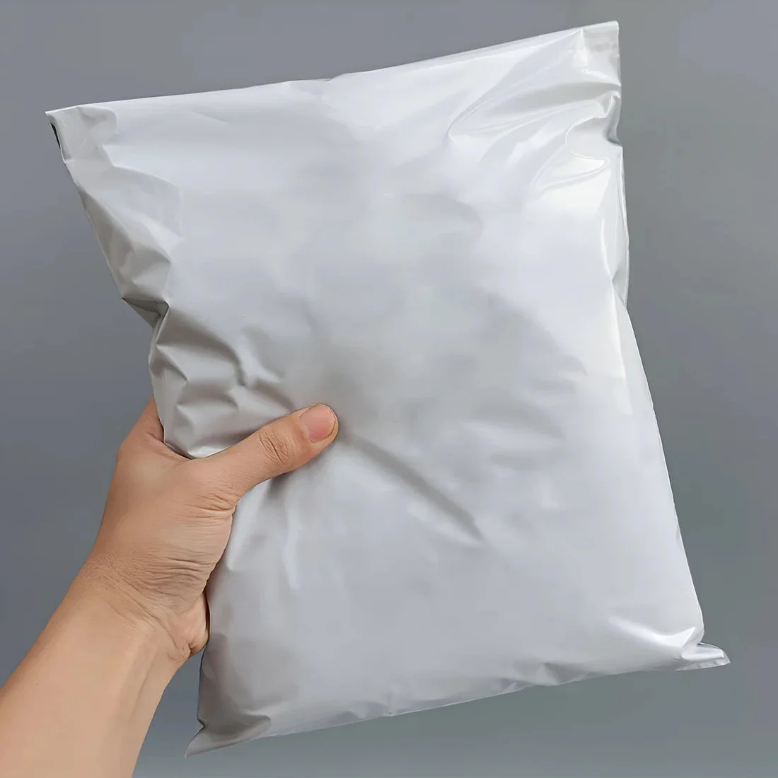 Stack of large waterproof self adhesive mail bags 40x55cm with peel-and-seal tamper-evident closure for secure shipping