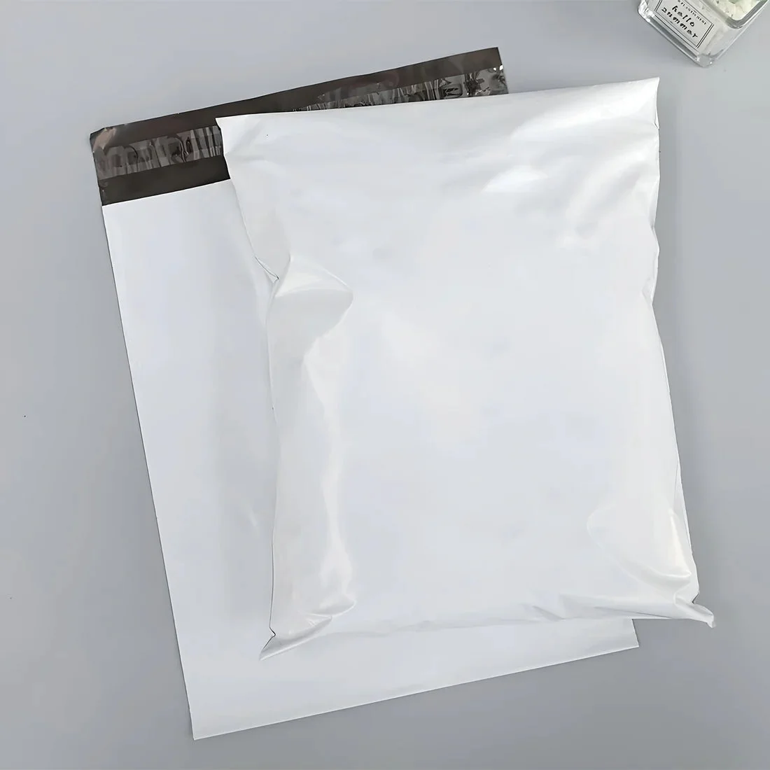 Stack of coloured poly mailers in various bright shades, made from durable polyethylene with self-adhesive seal