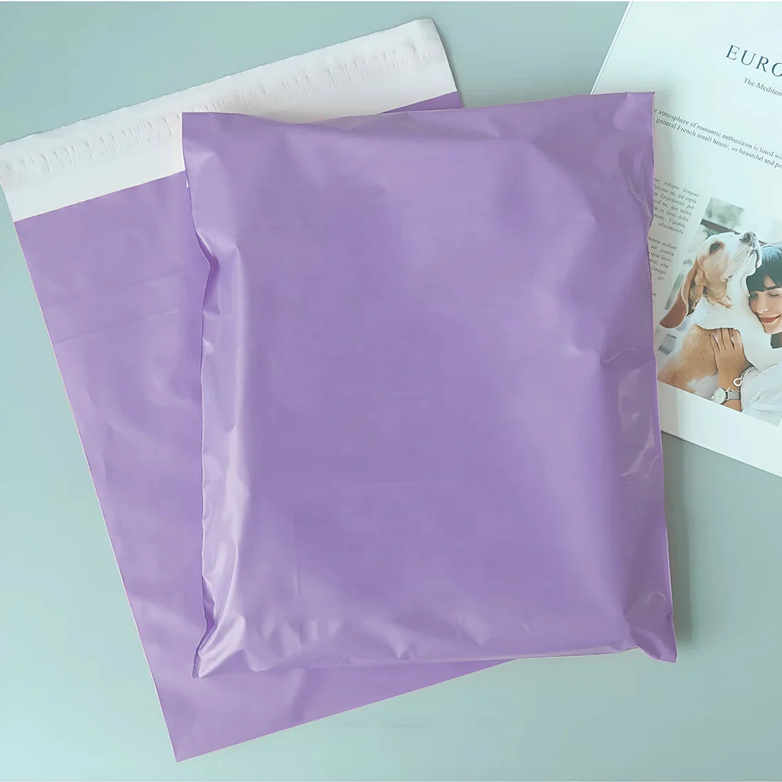 Stack of colorful self-adhesive mail bags made of durable polyethylene, measuring 35cm by 45cm, shown flat and sealed