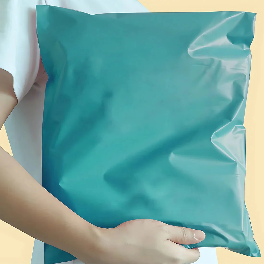Stack of colorful waterproof mailing envelopes made of durable polyethylene with self-adhesive seal, 35x45cm size