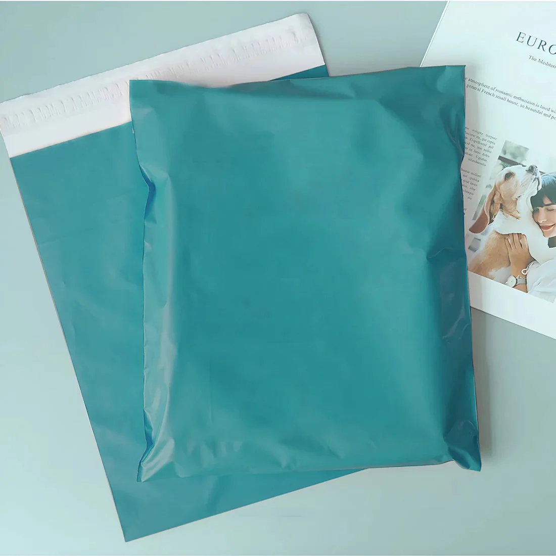 Stack of coloured poly mailers in various shades, each with self-adhesive seal, sized 35x45cm for durable packaging