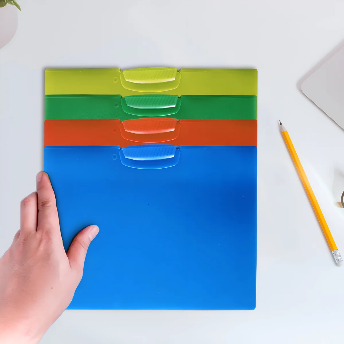 Set of four transparent plastic A4 document folders with front swing clips and rounded corners on white background