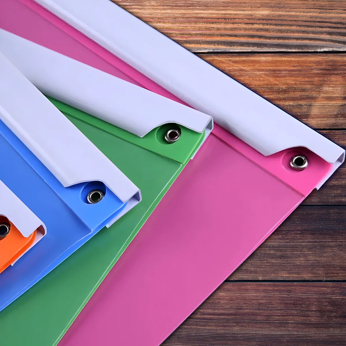 Six A4 size polypropylene report folders in assorted colors, stacked and showing rotating lever clip design for secure papers
