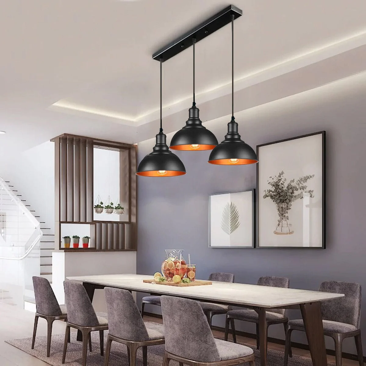 Three black metal dome vintage retro pendant lights hanging from adjustable cables on a white ceiling background